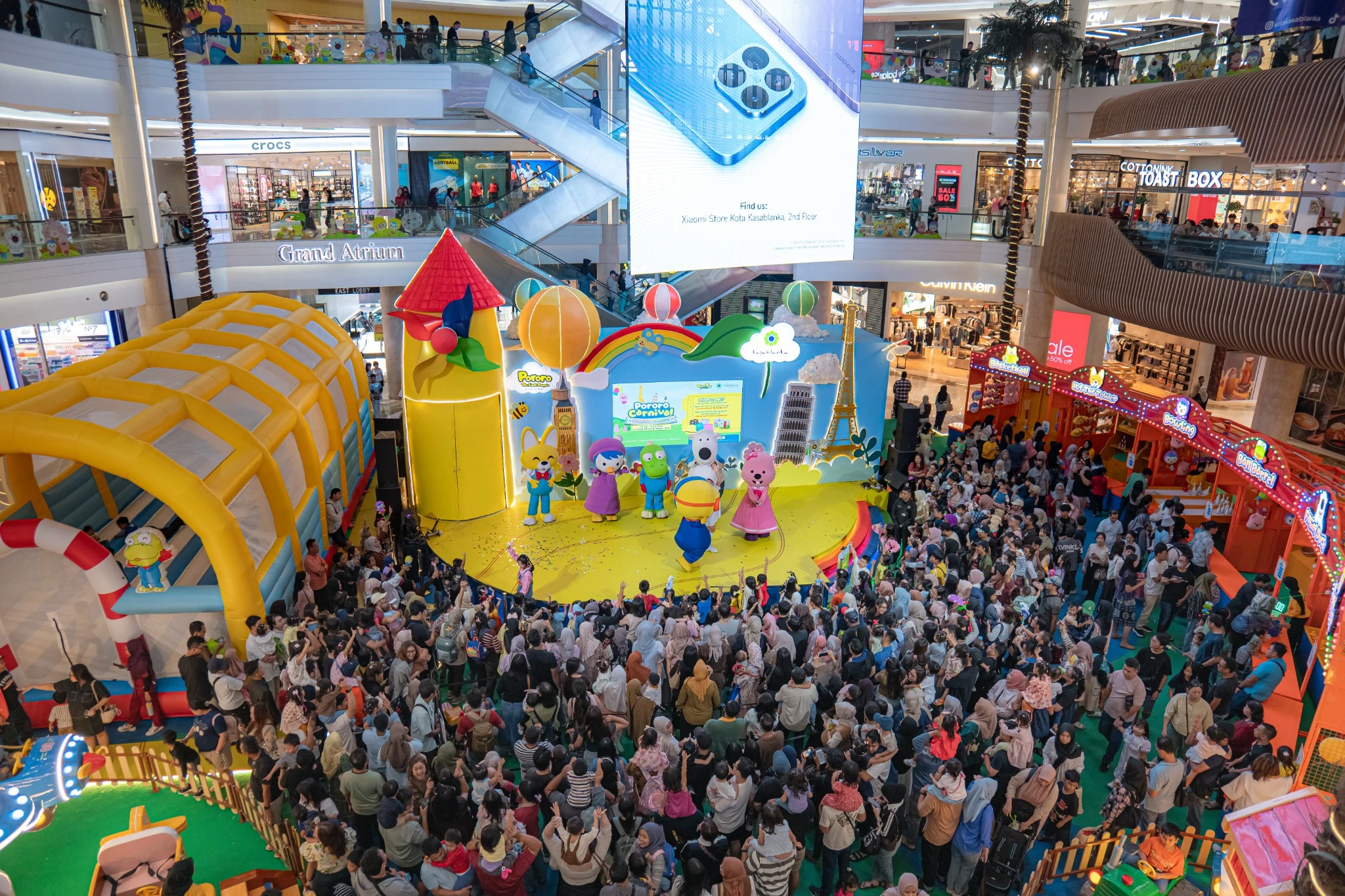 Families gathered around the Pororo Carnival character show at a shopping mall