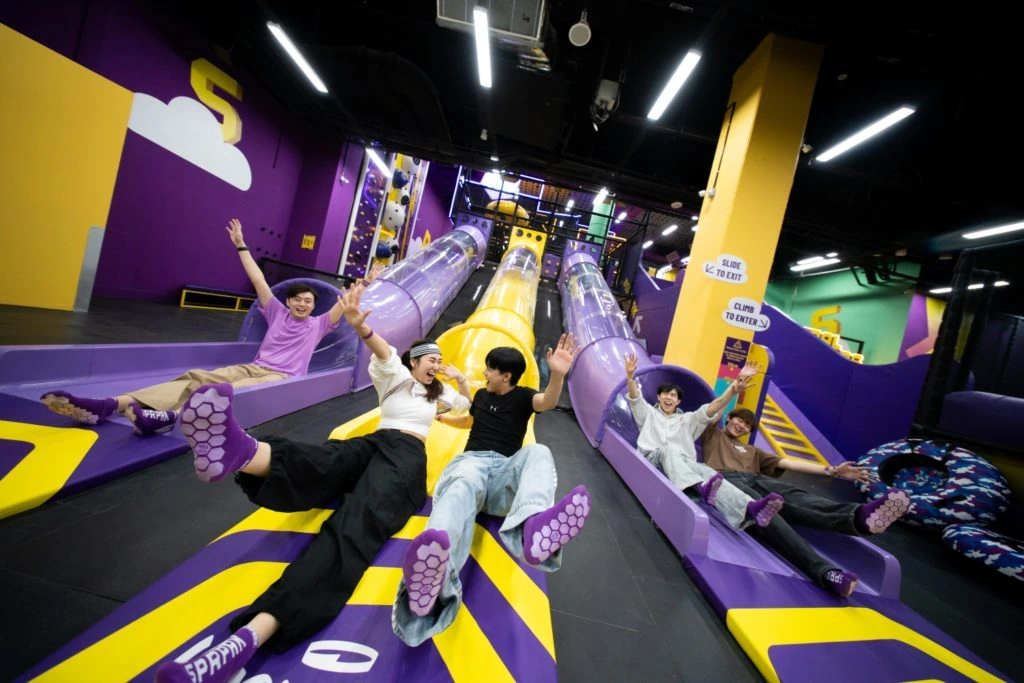 Guests enjoying a slide attraction at SuperPark